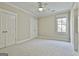Neutral bedroom with carpet flooring, natural light, and standard closet doors at 410 Denton Cir, Fayetteville, GA 30215