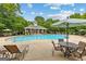 View of a sparkling community pool with lounge chairs, umbrellas and a pavilion at 410 Denton Cir, Fayetteville, GA 30215