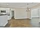 Open dining area features modern chandelier and hardwood floors at 410 Denton Cir, Fayetteville, GA 30215