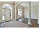 Open-concept foyer with large windows, columns, and a decorative chandelier at 410 Denton Cir, Fayetteville, GA 30215