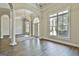 Elegant foyer showcasing hardwood floors, columns, and natural light at 410 Denton Cir, Fayetteville, GA 30215