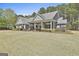 Attractive single-story home with lush landscaping and a covered front porch at 410 Denton Cir, Fayetteville, GA 30215