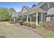 Lovely single-story home features landscaped beds and a welcoming front porch with columns at 410 Denton Cir, Fayetteville, GA 30215