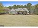 Beautiful single-story home features a manicured lawn and inviting front porch with columns at 410 Denton Cir, Fayetteville, GA 30215