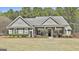 Charming single-story home features manicured landscaping, traditional design, and a welcoming front porch at 410 Denton Cir, Fayetteville, GA 30215