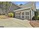Attached garage with painted doors and manicured landscaping at 410 Denton Cir, Fayetteville, GA 30215