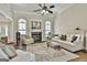 Bright living room with fireplace, ceiling fan, and ample seating creates a cozy atmosphere at 410 Denton Cir, Fayetteville, GA 30215