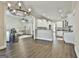 Open floor plan showcasing the kitchen and living room, enhanced by hardwood floors and modern lighting at 410 Denton Cir, Fayetteville, GA 30215
