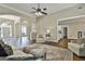 Spacious living room with beautiful dark floors, and open archways leading to other rooms at 410 Denton Cir, Fayetteville, GA 30215