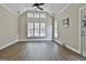 Bright living room with large windows offering plenty of natural light and beautiful ceiling fan at 410 Denton Cir, Fayetteville, GA 30215
