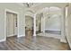 Open-concept living area with hardwood floors, columns, and natural light at 410 Denton Cir, Fayetteville, GA 30215