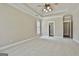 Large main bedroom boasting tray ceilings, carpet, and ample natural light at 410 Denton Cir, Fayetteville, GA 30215