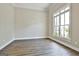 Bright room with hardwood floors, crown molding, and natural light from a large window at 410 Denton Cir, Fayetteville, GA 30215