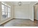 Bright room with hardwood floors, crown molding, and natural light from a large window at 410 Denton Cir, Fayetteville, GA 30215