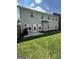 Spacious backyard with a concrete patio, grassy lawn, and fenced perimeter, perfect for outdoor activities at 2470 Wevok Way, Grayson, GA 30017