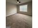 Bedroom with new carpeting, neutral paint, ceiling fan, and natural light from the window at 2470 Wevok Way, Grayson, GA 30017