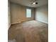 Bedroom featuring new carpeting, neutral paint colors, and a window with white trim at 2470 Wevok Way, Grayson, GA 30017