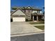 Two-story home featuring a brick and siding exterior, a two-car garage, and a well-maintained lawn at 2470 Wevok Way, Grayson, GA 30017