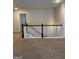 Upstairs hallway showcasing new carpeting, white banister railing with dark wood trim, and neutral paint at 2470 Wevok Way, Grayson, GA 30017