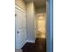 Hallway with two doors leading to a hall bath with tiled shower and toilet at 2470 Wevok Way, Grayson, GA 30017