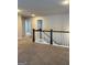Upstairs hallway featuring new carpeting, white banister railing with dark wood trim, and neutral paint colors at 2470 Wevok Way, Grayson, GA 30017