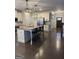 Open-concept kitchen with a large island, stainless steel appliances, and hardwood floors at 2470 Wevok Way, Grayson, GA 30017