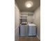 Laundry room featuring a washer and dryer, shelving, and tile flooring at 2470 Wevok Way, Grayson, GA 30017
