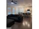 Open-concept living room and kitchen with hardwood floors, breakfast bar, and modern lighting at 2470 Wevok Way, Grayson, GA 30017