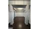 Bright living room with dark hardwood floors, wainscoting, and modern lighting at 2470 Wevok Way, Grayson, GA 30017
