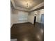 Spacious living room with dark hardwood floors, white wainscoting, and natural light at 2470 Wevok Way, Grayson, GA 30017