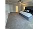 Spacious main bedroom with new carpeting, a tray ceiling, ceiling fan, and access to the ensuite at 2470 Wevok Way, Grayson, GA 30017