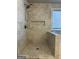 Modern tiled shower with built-in niche and rainfall showerhead in a luxurious bathroom at 2470 Wevok Way, Grayson, GA 30017