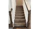 Carpeted stairs with white railings and wood banisters leading to the second floor at 2470 Wevok Way, Grayson, GA 30017