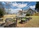 A spacious backyard with a lawn, garden planters, and a home exterior, offering an outdoor oasis for gardening and relaxation at 140 Jodeco Station Ter, Stockbridge, GA 30281
