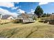 A spacious backyard with a well-maintained lawn, a deck, and mature trees providing privacy and shade at 140 Jodeco Station Ter, Stockbridge, GA 30281