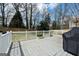 Wooden backyard deck with white railings, offering an outdoor living space with room for seating and a grill at 140 Jodeco Station Ter, Stockbridge, GA 30281