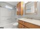 Bathroom featuring a shower-tub combo, wooden vanity, and updated fixtures at 140 Jodeco Station Ter, Stockbridge, GA 30281