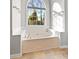 This bathroom is very spacious and features a large tub below an arched window at 140 Jodeco Station Ter, Stockbridge, GA 30281