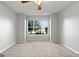Bright bedroom featuring neutral carpet and a large window with natural light at 140 Jodeco Station Ter, Stockbridge, GA 30281