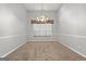 Open dining room with a neutral color palette and decorative light fixture at 140 Jodeco Station Ter, Stockbridge, GA 30281