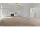 Spacious living room features a fireplace, ceiling fan, and plenty of natural light at 140 Jodeco Station Ter, Stockbridge, GA 30281