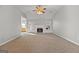 Living room features a fireplace, ceiling fan, and view of an outdoor patio at 140 Jodeco Station Ter, Stockbridge, GA 30281