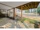 A covered outdoor patio featuring stone pavers and wooden supports, seamlessly blending with the landscaped backyard at 140 Jodeco Station Ter, Stockbridge, GA 30281