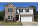 Charming two-story home featuring a brick and siding exterior, a two-car garage, and a well-manicured front lawn at 2369 Argento Cir, Dacula, GA 30019