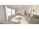Cozy living room with large windows, neutral tones, comfortable seating, and stylish decor at 2369 Argento Cir, Dacula, GA 30019