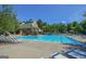 Large community pool with plenty of lounge chairs and umbrellas under a sunny sky at 3626 Lone Indian Trl, Marietta, GA 30066