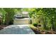 Charming two-story home with a well-manicured lawn and attached two car garage, surrounded by lush trees at 3626 Lone Indian Trl, Marietta, GA 30066