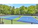 Brightly colored blue and green outdoor tennis court with well-maintained surface and surrounding fencing at 3626 Lone Indian Trl, Marietta, GA 30066