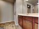 Bathroom featuring wood-look vinyl floors, wooden vanity with sink and a large mirror at 3713 Upland Dr, Mcdonough, GA 30253