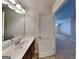 Bright bathroom featuring a vanity, sink, and a mirror with stylish lighting fixtures at 3713 Upland Dr, Mcdonough, GA 30253